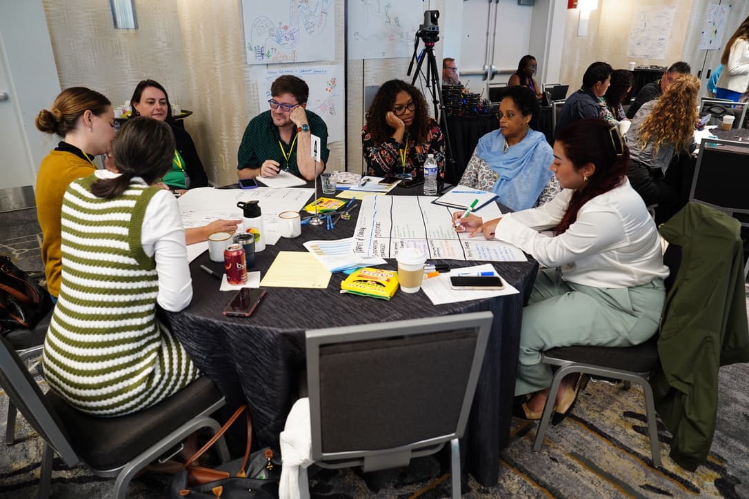 Community researchers collaborating around a table during a working session